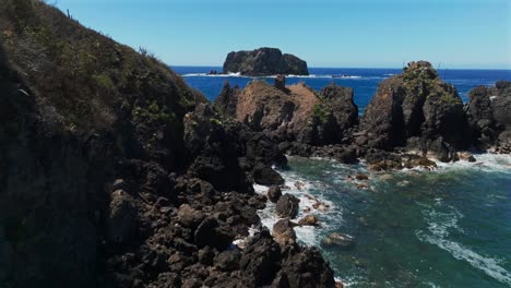 waves crashing against the rocky coast and cliffs at playa la morita in tenacatita, jalisco, mexico. - aerial shot