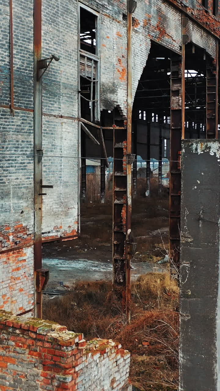 Abandoned industrial building. Ruins of an old factory. Aerial view Vertical video