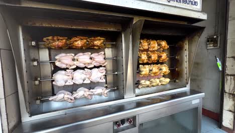 chickens roasting on a rotisserie in nakhon nayok