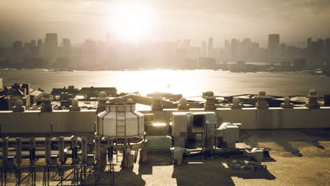 golden sunrise over city skyline seen from an industrial rooftop