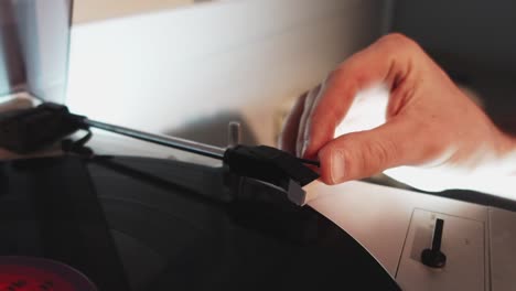 A-close-up-shot-of-a-man-hands-use-retro-vinyl-player-to-enjoy-the-retro-music