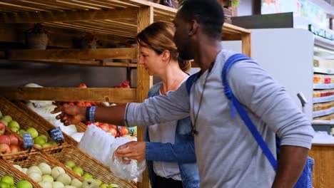 exploring fresh produce: a dynamic shopping experience at a local market with friends and family selecting colorful fruits and vegetables together