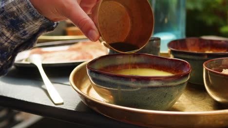 person pouring soup