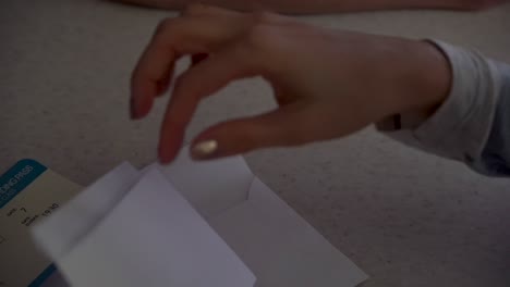 opening an envelope with a ticket inside