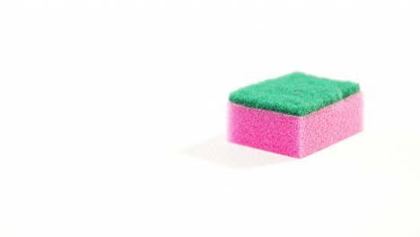 Plastic-cleaning-sponge-falling-on-white-background