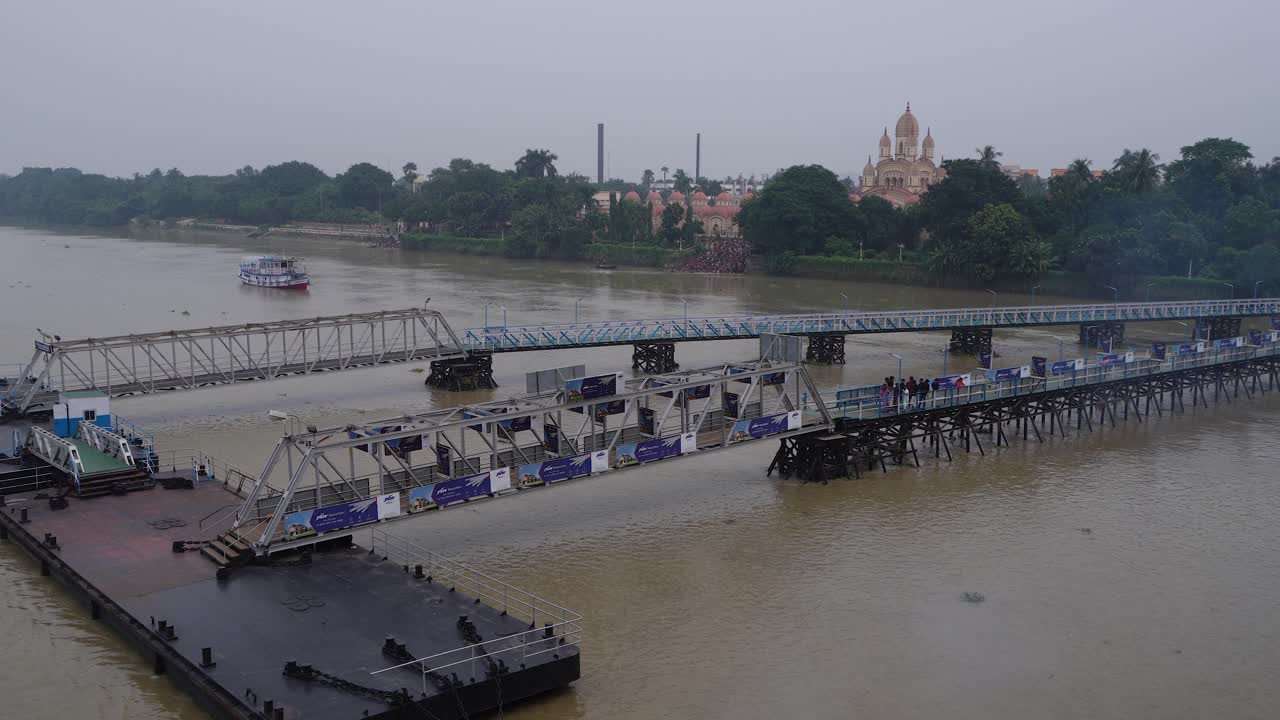 People are boarding the ship from the wharf.