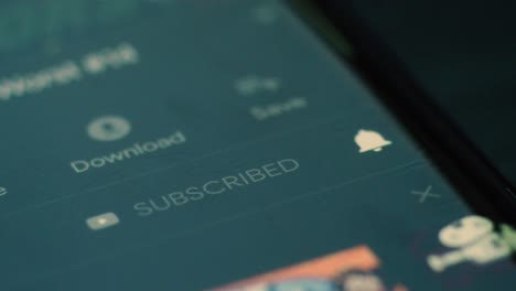 closeup of person subscribing to youtube channel on android smartphone youtube app