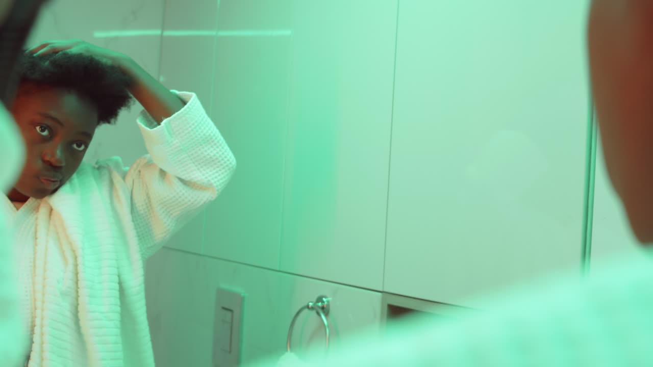 Black Woman Drying Hair after Shower in Bathroom