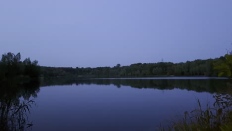 evening-calm-lake-with-trees-at-the-edge-Höhenfelder-See-in-cologne-germany-in-the-evening