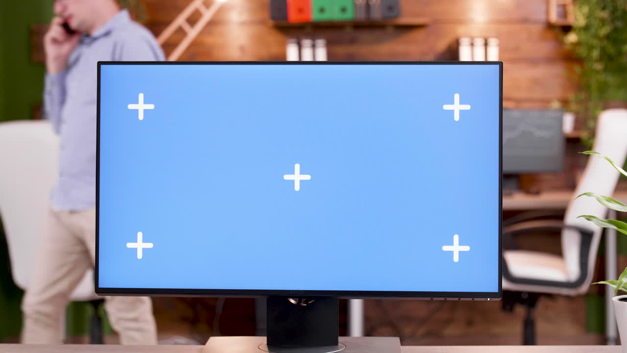 Computer monitor with a blue screen in an office setting