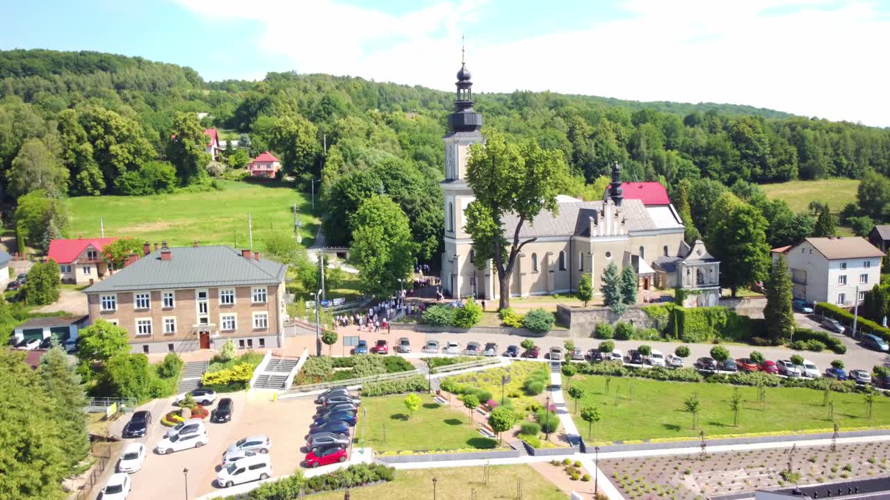 Aerial View of a European Village with a Historic Church and Bell Tower