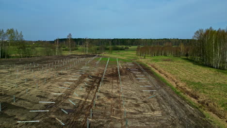 Installing-posts-erect-a-solar-panel-power-system---pullback-aerial-reveal