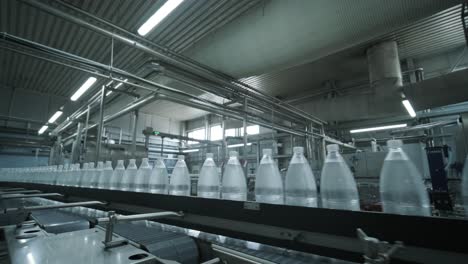 conveyor belt with bottles of drinking water at a modern beverage plant