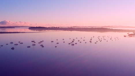 Atemberaubende-Landschaft-Mit-Farbenfrohem-Sonnenaufgang,-Der-Auf-Dem-Ruhigen-Wasser-Mit-Yachten-Und-Segelbooten-In-Auckland,-Neuseeland,-Scheint-Und-Reflektiert