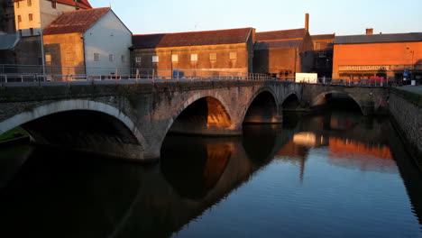 stone bridge over a river at sunset
