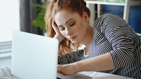 Tracking-right-video-of-bored-woman-with-laptop