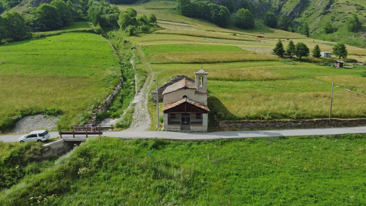 Small church in the countryside next to narrow road