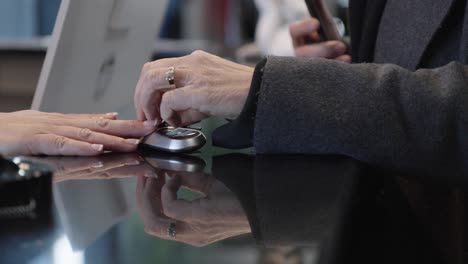 Close-up-of-handing-over-car-keys-in-dealership