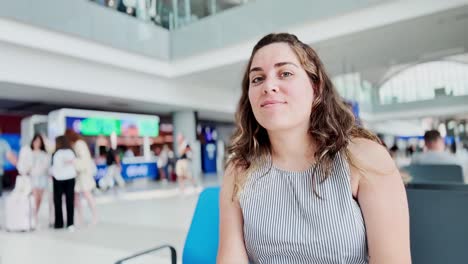 female traveler selfie in an airport concourse