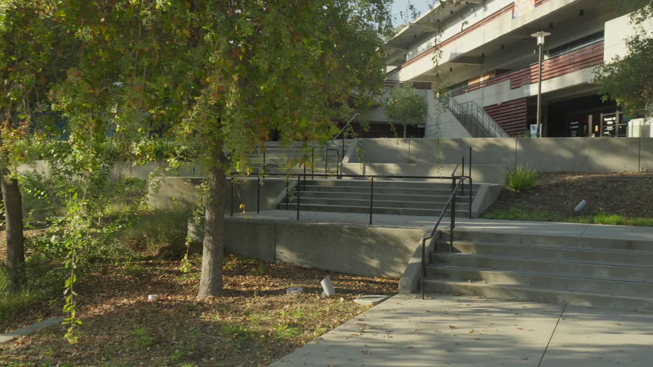 Foothill College comes into sharp detail as the lens advances, revealing geometric rooftops, tree-lined paths, and modern learning spaces