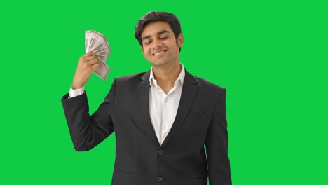 Happy-Indian-businessman-using-money-as-fan-Green-screen