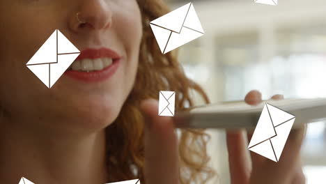 animation of envelope icons falling over caucasian woman using smartphone