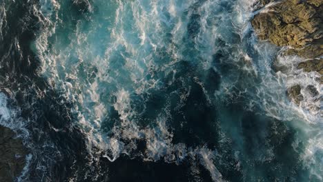 waves breaking against the rocky coastline of laxe in spain