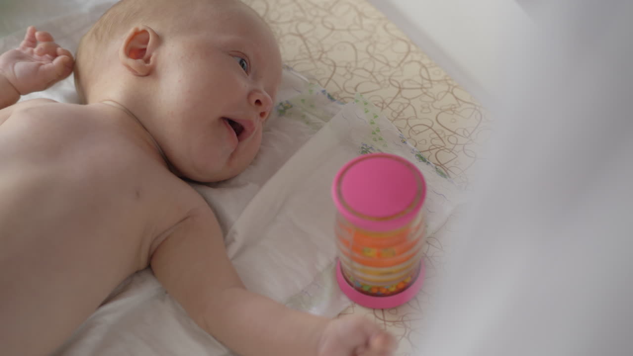 Two months baby and rattle-box toy
