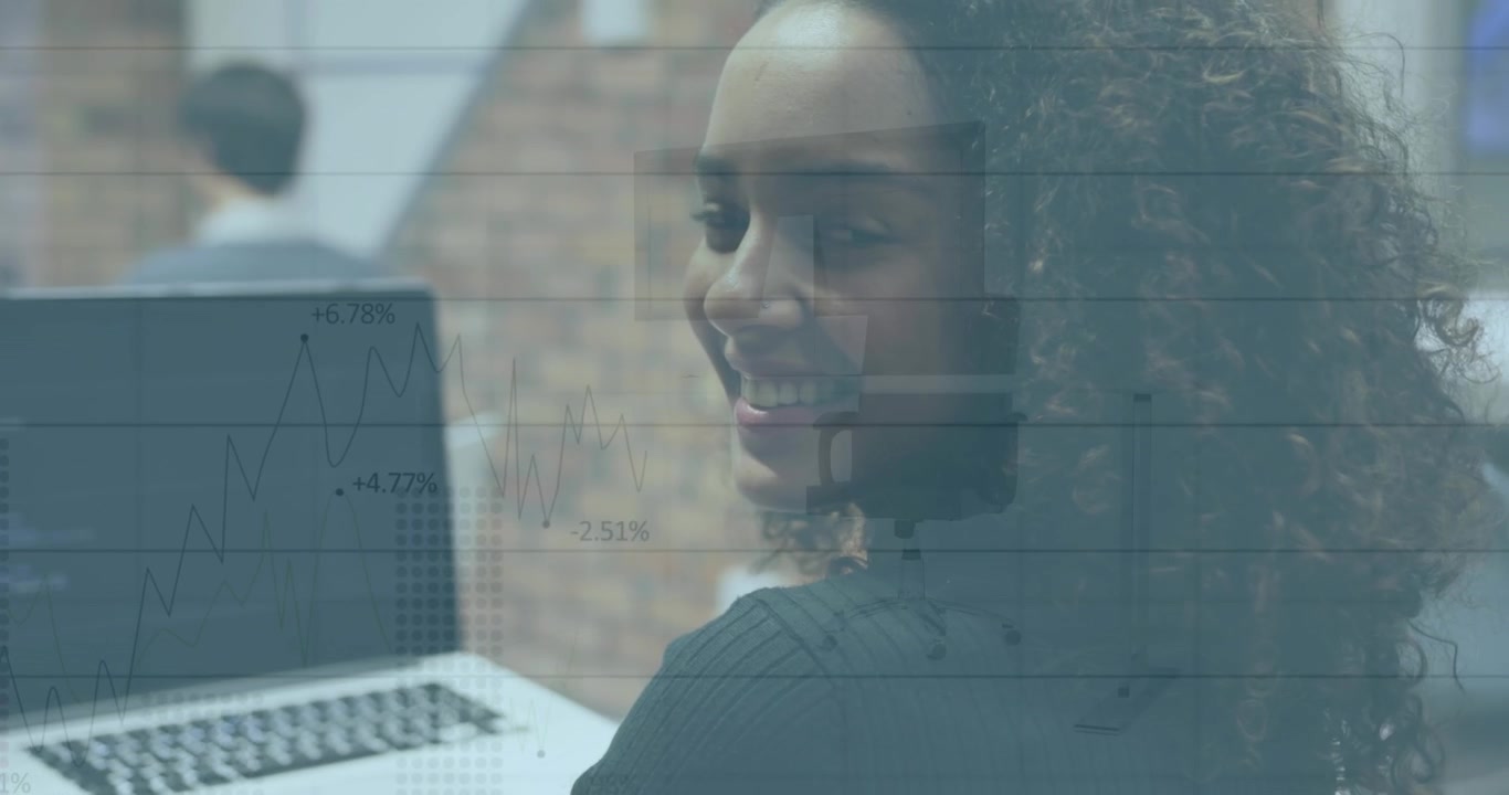 Young Woman Working on Laptop in Office with Data Overlay