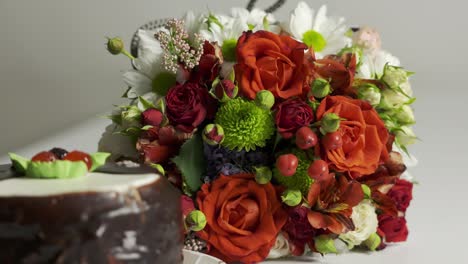 mixed flower arrangement and cake. mix of fresh flowers with red roses