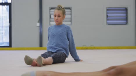 Female-gymnasts-performing-at-sports-hall