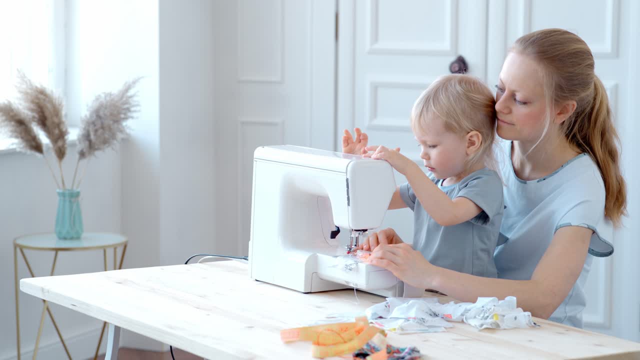 Mother and child learning to sew together