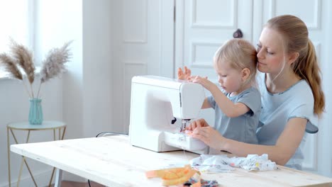 mother and child learning to sew together