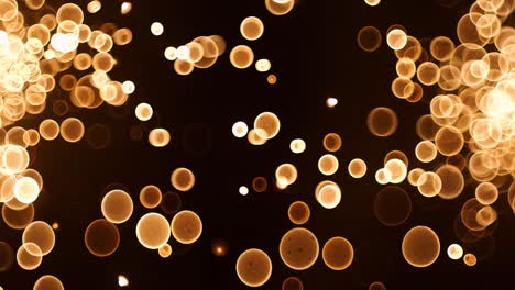 el brillo abstracto de las partículas de burbujas de bokeh de oro que vuelan sobre un fondo negro, las partículas de bokeh del oro rojo naranja y el polvo vuelan en el aire en la cámara de cámara súper lenta de 1000 fps.