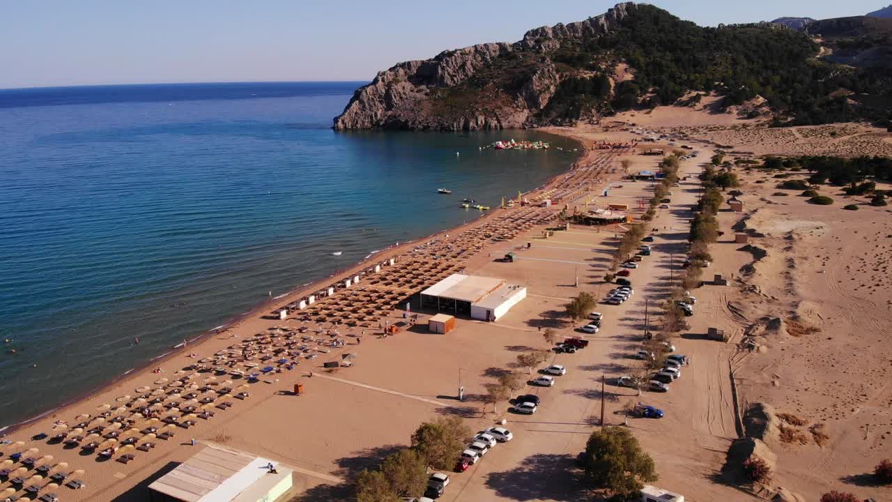 Eating Establishments And Parked Cars On Famous Tsambika Beach On Rhodes Island In Greece