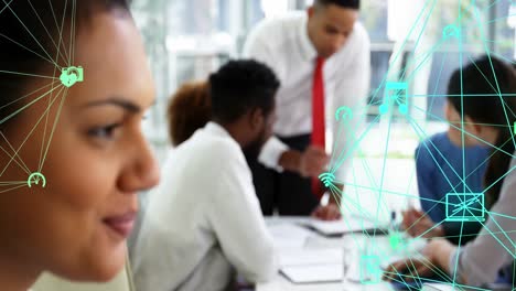 Animation-of-globes-of-digital-icons-spinning-against-portrait-of-biracial-woman-smiling-at-office