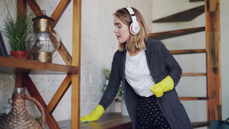 woman cleaning a home with headphones