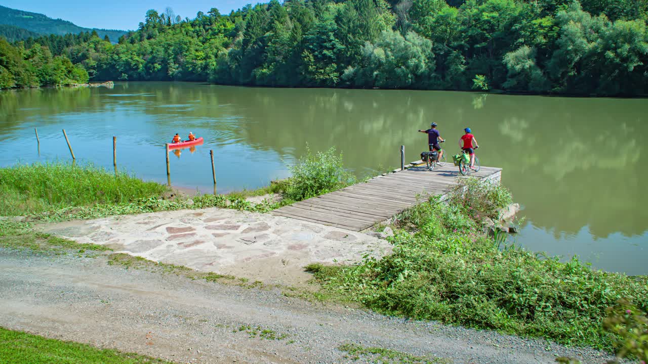 Cinematic view of friends doing sport activities at the Alpine Drava River, Muta