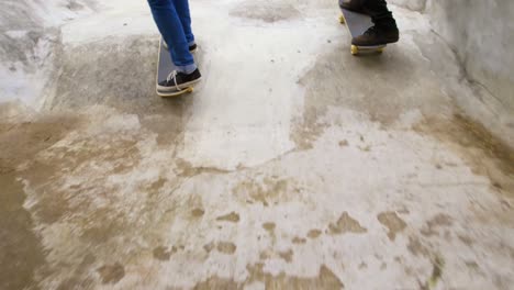 Rear-view-of-young-man-practicing-skateboarding-on-ramp-in-skateboard-park-4k