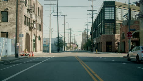 empty city street with buildings and power lines