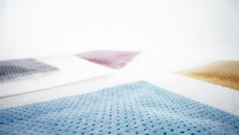 soft focus on varied hues of sponges against a white background