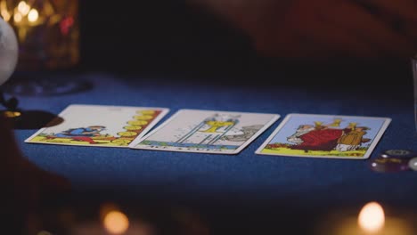 Close-Up-Of-Woman-Giving-Tarot-Card-Reading-To-Man-On-Candlelit-Table-7