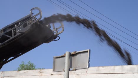 view of the conveyor belt of a milling machine during highway road repair