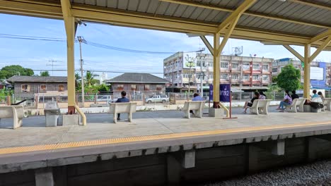 people waiting at a bustling train station