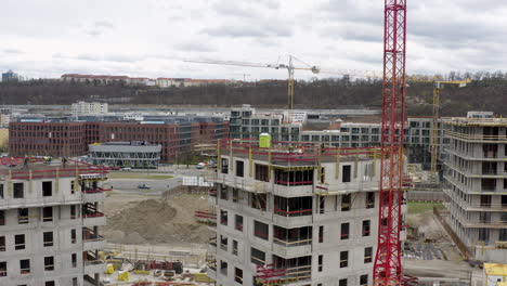 Concrete-buildings-under-construction-with-tower-cranes-around,-Prague