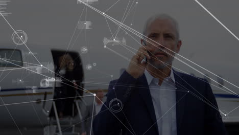 animación del procesamiento de datos sobre un hombre de negocios caucásico hablando por teléfono inteligente