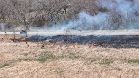 fire fighters contain a grass fire