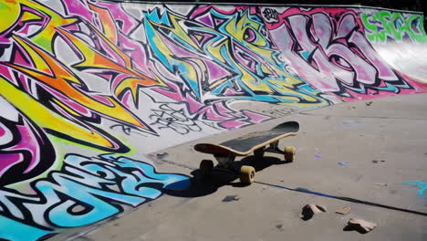 skateboard at a skatepark with graffiti