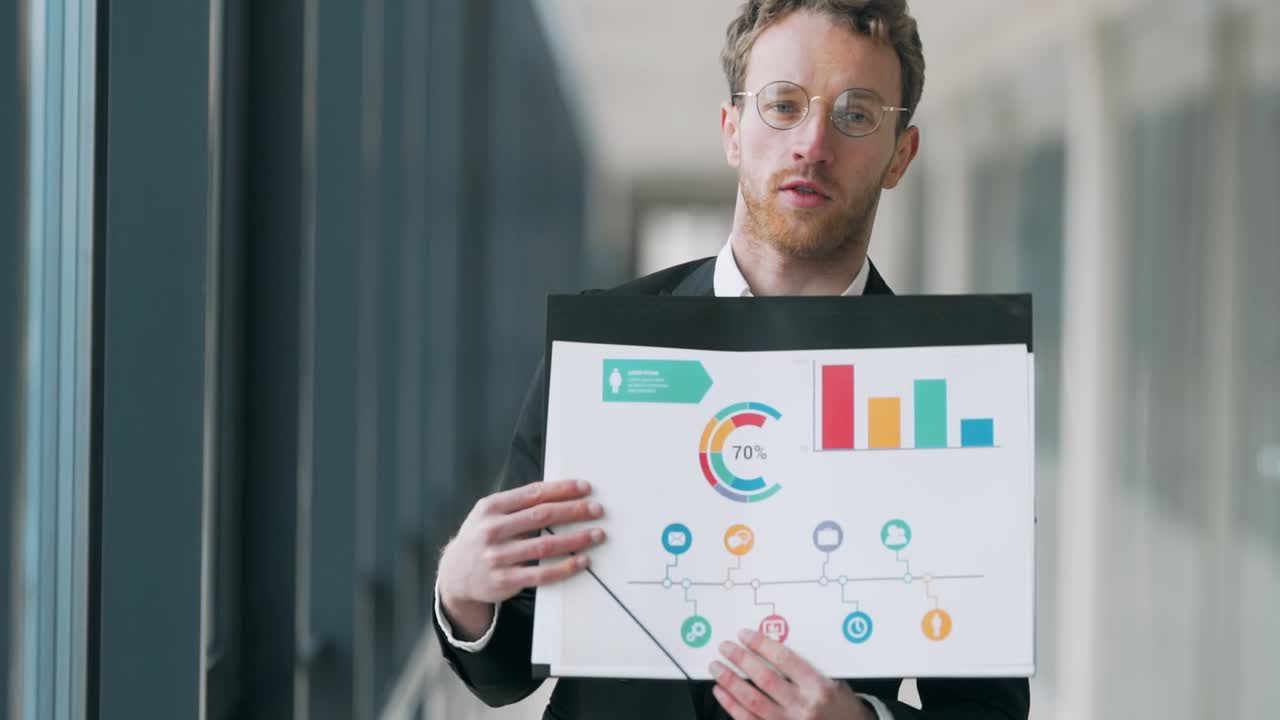 Handsome nice man makes a presentation on infographics