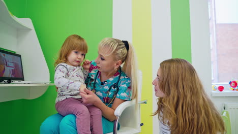 pediatrician doctor examining child. pediatrician doctor examining kid girl